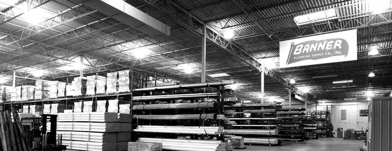 Monochrome image of a warehouse, showcasing the industrial architecture and vast space within.